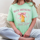 Beer Drinkers Social Club DTF Heat Transfer, graphic of a beer glass with a pink bow and decorative leaves, on a pastel green t-shirt.