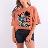 Roaring Cheetah Disco Ball DTF Heat Transfer, trendy graphic t-shirt featuring a roaring cheetah, disco ball, palm tree, and pool drink design worn by a woman.