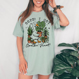 Oops I Got Another Plant DTF Heat Transfer, image of a woman wearing a T-shirt with a cartoon duck surrounded by plants and the text "Oops! I Got Another Plant!".