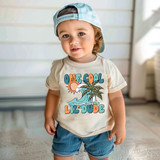 Retro One Cool Lil Dude DTF Heat Transfer, graphic of a tropical scene with a sun, waves, and palm trees with the text "One Cool Lil Dude" on a child's t-shirt.