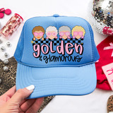 Golden & Glamorous DTF Heat Transfer, embroidered on a light blue baseball cap with illustrations of stylish women wearing pink sunglasses.