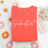 Godmother Script DTF Heat Transfer on coral pink T-shirt, showcasing a stylish design for custom apparel.