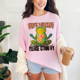 God’s Working on Me – Please Stand By DTF Heat Transfer, pink T-shirt with colorful frog and text design.