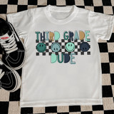 Retro Dude Back To School DTF Heat Transfer, a white T-shirt with a colorful graphic design for third-grade students featuring smiling face icons and checkered background.