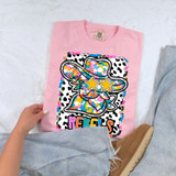 Dotted Graffiti Mascot DTF Heat Transfer, colorful graffiti-style design of a mascot with star-shaped sunglasses on a pink T-shirt.