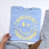 He Has A Plan I Have A Purpose Happy Face LIGHT YELLOW DTF Heat Transfer T-Shirt, light blue t-shirt with yellow happy face design and phrase printed on the front.