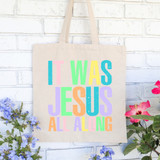 Colorful It Was Jesus All Along DTF Heat Transfer, tote bag with vibrant pastel-colored text 'It Was Jesus All Along' printed on beige fabric.