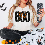 Lacey Boo DTF Heat Transfer, close-up of Halloween-themed apparel with a black, orange, and white design featuring bows and accents.
