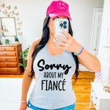 Sorry About My Fiance DTF Heat Transfer, woman wearing a tank top with the slogan 'Sorry About My Fiance' and a pink cap with smiley face logo.