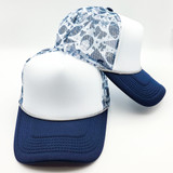 Football Medley Team Colors Foam Trucker Hat, two hats with reinforced front panels, mesh back panels, and curved brims in navy blue and white with a textured football pattern.