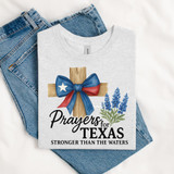 Prayers For Texas Stronger Than The Waters DTF Heat Transfer, printed T-shirt with a wooden cross, blue and red bow with Texas star, and lavender flowers design.