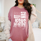 It Was Jesus All Along WHITE DTF Heat Transfer, white text design on a pink T-shirt worn by a woman in a cozy bedroom setting.