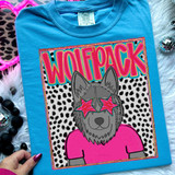 Wolfpack Colorful Mascot DTF Heat Transfer, vibrant colorful design of a wolf mascot wearing pink star-shaped glasses and a pink shirt, on a blue t-shirt.