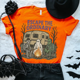 Escape The Ordinary DTF Heat Transfer, Halloween-themed orange T-shirt with skeleton, ghost, and Frankenstein graphic around a campfire, with Halloween decorations like a black hat, spider web bag, and bats.