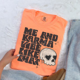 Distressed Me And Karma Vibe Like That DTF Heat Transfer, coral pink t-shirt with black distressed design and skull with heart-shaped eyes.
