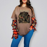 Creep Show DTF Heat Transfer, graphic horror-themed T-shirt with a spooky zombie reading a comic book and surrounded by candles, skulls, and horror elements, promoting suspense and horror stories.