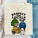 Respect The Locals Future Farmer DTF Heat Transfer T-shirt, featuring a cartoon cow in a blue jacket, hay bales, and a sign that reads 'Future Farmer' against a white background.