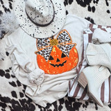 Sequin Pumpkin with Leopard Bow Patch, Halloween-themed clothing with a glowing pumpkin design, paired with white boots and a leopard print hat.