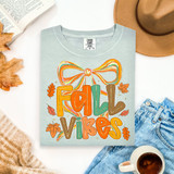 Fall Vibes Bow DTF Heat Transfer, colorful autumn-themed graphic with a large bow and leaves on a light gray T-shirt.