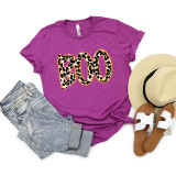 Leopard Boo DTF Heat Transfer, colorful leopard print 'BOO' design on purple t-shirt surrounded by summer accessories like jeans, straw hat, and sandals.