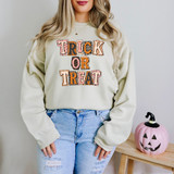 Trick Or Treat Patchwork DTF Heat Transfer, colorful Halloween-themed design on a light-colored sweatshirt.