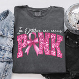 In October We Wear Pink Faux Embroidery DTF Heat Transfer T-shirt, grey shirt with pink glittery text and pink ribbon bow for Breast Cancer Awareness.