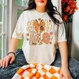 Gobble Patterned Retro DTF Heat Transfer, a colorful graphic design on a white t-shirt featuring fall-themed patterns and an orange bow, with autumn leaves and floral motifs.