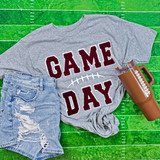 Game Day with Silicon Laces Patch - 10 Colors, gray T-shirt with 'GAME DAY' embroidery, distressed denim shorts, and a brown tumbler cup on a green turf background.