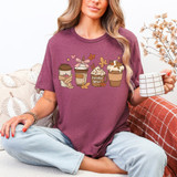 Fall Coffee DTF Heat Transfer, colorful coffee cup designs with autumn leaves and cat motifs on a woman's purple T-shirt.
