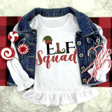 Elf Squad Glitter Effect Christmas Sublimation Transfer, festive holiday design on a white shirt with red and green glitter accents, placed with candy canes, peppermint candies, and a denim jacket on a holiday-themed background.