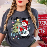 Caffeine & Christmas Cheer Diet Cola DTF Heat Transfer, holiday-themed design featuring a smiling snowman wearing a red hat and scarf hugging a Christmas tree, surrounded by colorful Christmas lights and snowflakes.