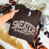 Sweater Weather Brown Camo DTF Heat Transfer, a folded dark brown sweatshirt with 'SWEATER weather' text in camouflage pattern and script font.