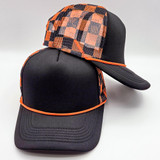 Black and Orange Checkered Foam Trucker Hat, stylish baseball cap with a checkered pattern on the front mesh panel and a curved brim.