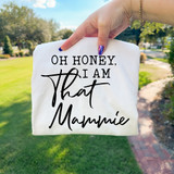 Oh Honey, I Am That Mammie DTF Heat Transfer, product showcasing a white fabric with black text saying 'Oh Honey, I Am That Mammie' being held outdoors.