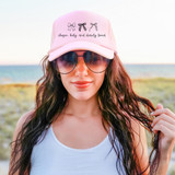 Chosen, Holy, and Dearly Loved Bow BLACK DTF Heat Transfer, black bows and cursive text design on a pink baseball cap worn by a woman outdoors.