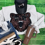 Sequin Bear Starry Eyes Mascot Patch, a sparkling embroidered patch featuring a bear's face with starry eyes and an open mouth with sharp teeth, placed on a gray sweatshirt.