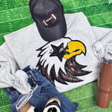 Sequin Eagle Starry Eyes Mascot Patch, a glittery embroidered patch of an eagle with starry eyes and a yellow beak, on a grey fabric background.