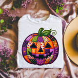 Patchwork Pumpkin Faux Embroidery DTF Heat Transfer, colorful halloween pumpkin design on a white t-shirt.