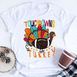 Touchdowns and Turkey Thanksgiving Football Sublimation Transfer, colorful Turkey design with football body and vibrant tail feathers on a white T-shirt.
