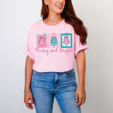 Pastel Merry And Bright DTF Heat Transfer, pink t-shirt with Christmas tree graphics and festive lettering.
