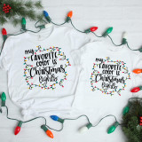 My favorite Color is Christmas Lights, sublimation transfer design on white t-shirts featuring colorful Christmas light string illustration.