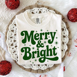 Retro Merry & Bright GREEN DTF Heat Transfer, holiday-themed design on a white T-shirt with green festive text and star accents.