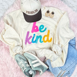 Be Kind Multicolor Fluffy Chenille Patch, colorful fluffy chenille patch with the words 'be kind' on an off-white sweatshirt.