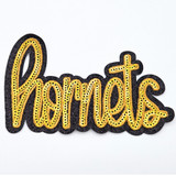 Hornets Gold Sequin HAT/POCKET Patch, embroidered patch with gold sequins spelling out 'Hornets' on a black fabric background.