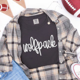 Wolfpack White PUFF Transfer, white decorative text transfer on black T-shirt, casual layered outfit with plaid shirt, sneakers, and footballs in the background.