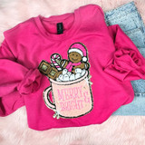 Coco Cup Chenille Patch, pink sweatshirt with Christmas-themed chenille patch featuring a smiling gingerbread man in a hot chocolate mug with marshmallows, peppermint candy, and chocolates, and the text 'MERRY & BRIGHT'.
