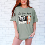 Love Your Herd DTF Heat Transfer, t-shirt with watercolor style illustration of three cows and the text Love Your Herd.