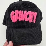 Grinchy Pink Fluffy HAT Patch, a black corduroy cap with pink fluffy embroidery spelling 'Grinchy' on the front.