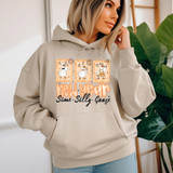 New Year, Same Silly Goose DTF Heat Transfer on a woman's beige hoodie with illustrated duck characters and festive decorations, celebrating the new year in a fun and cute style.