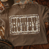 Howdy Camo DTF Heat Transfer, camo-themed heat transfer design with the word 'Howdy' inside a rectangle on a brown T-shirt.